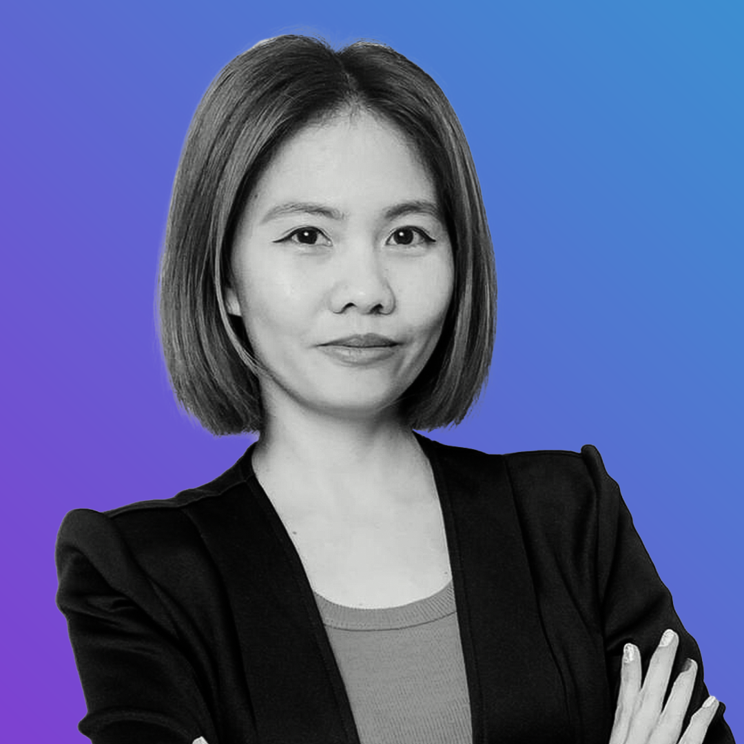 A person with a short bob haircut wearing a blazer looks at the camera against a blue gradient background. OCIDM,io Branding and Digital marketing Hamilton, Toronto, Oakville, Mississauga