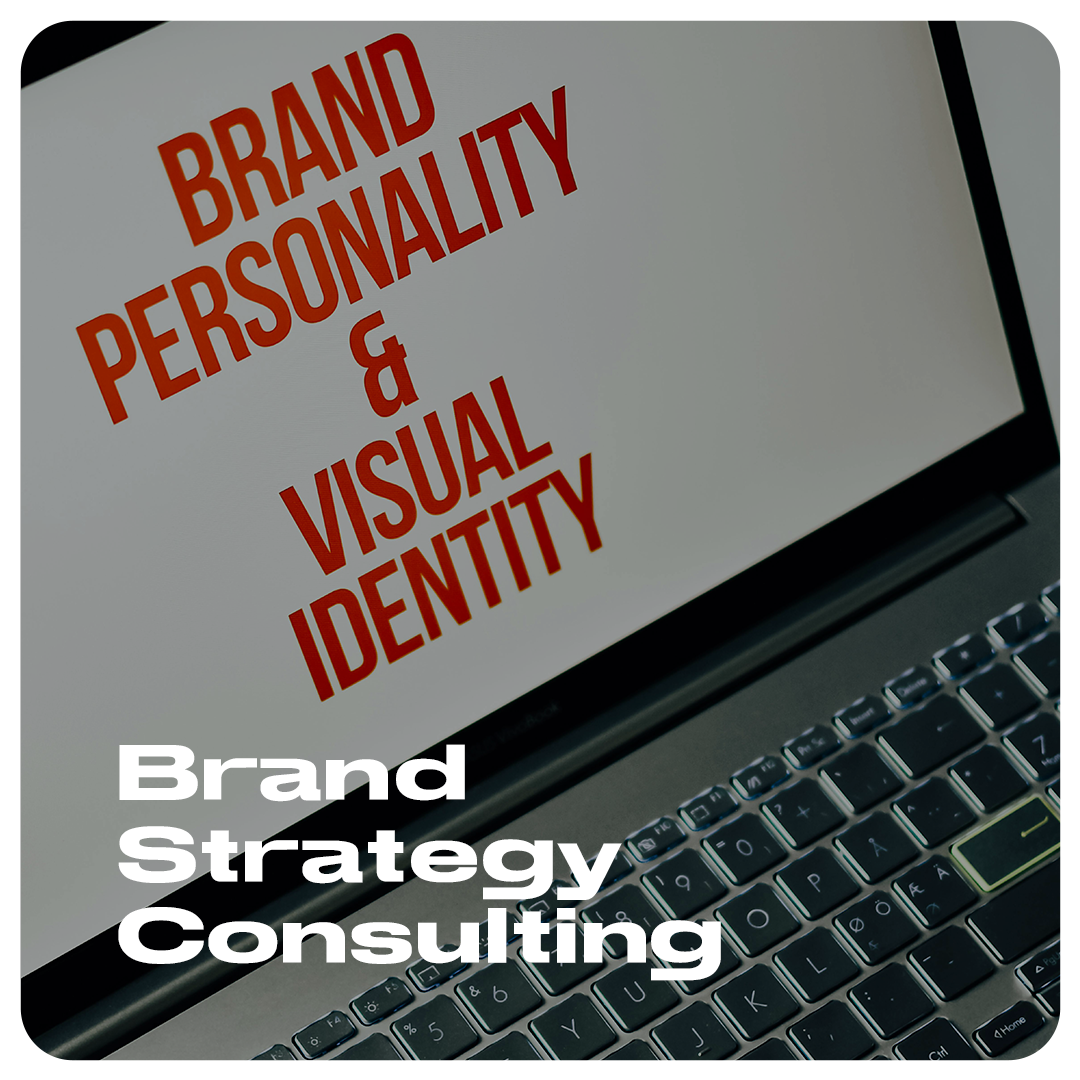 Close-up of an open laptop showing the words "Brand Personality & Visual Identity" on the screen. Below the laptop keyboard, the text "Brand Strategy Consulting" is displayed. OCIDM,io Branding and Digital marketing Hamilton, Toronto, Oakville, Mississauga